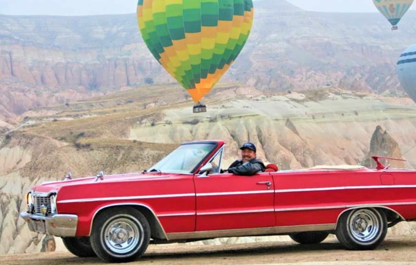 a man driving vintage car at Cappadocia Classic Car Tour