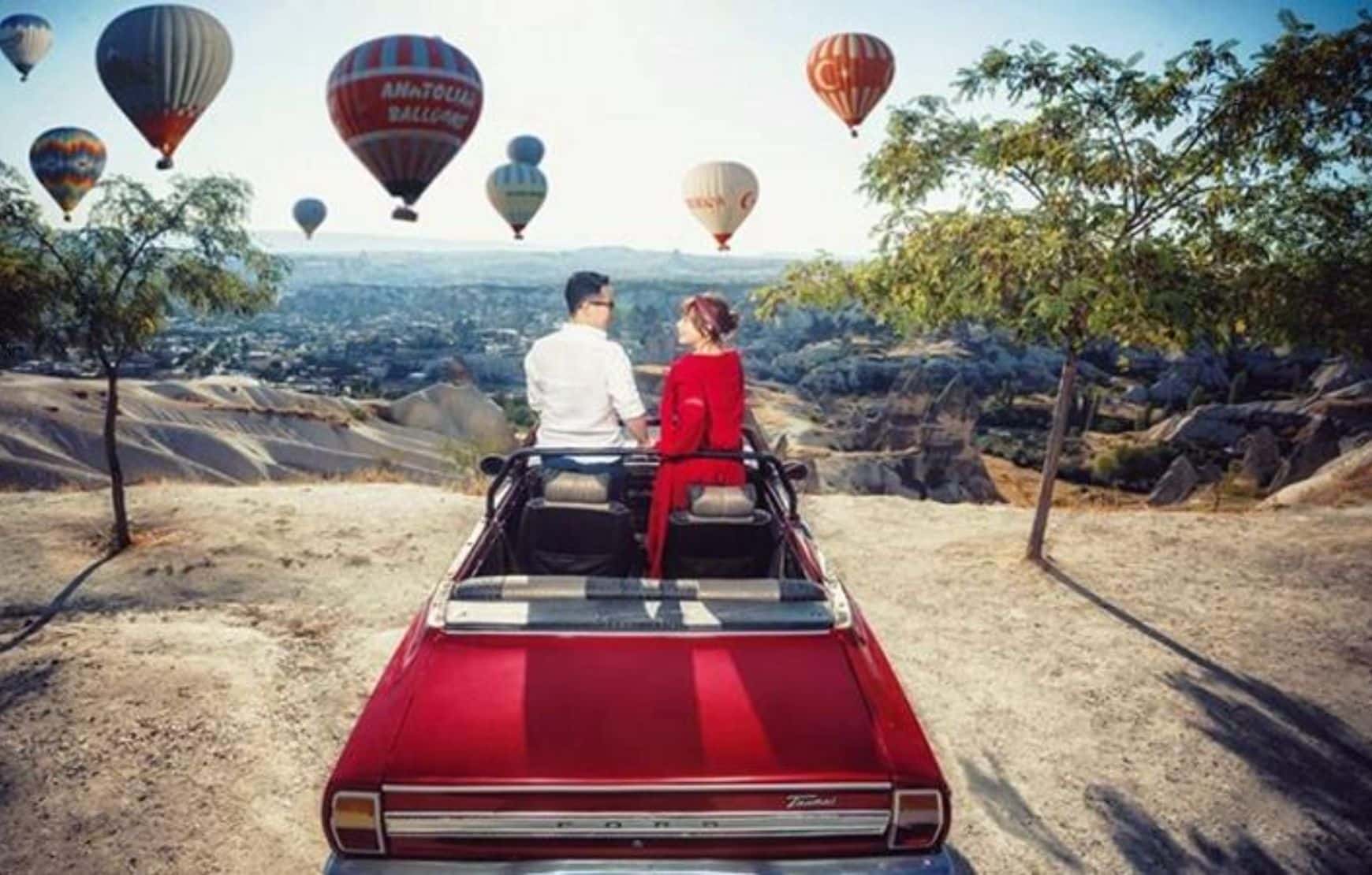 a honemoon couple taking picture at our Cappadocia Classic Car Tour