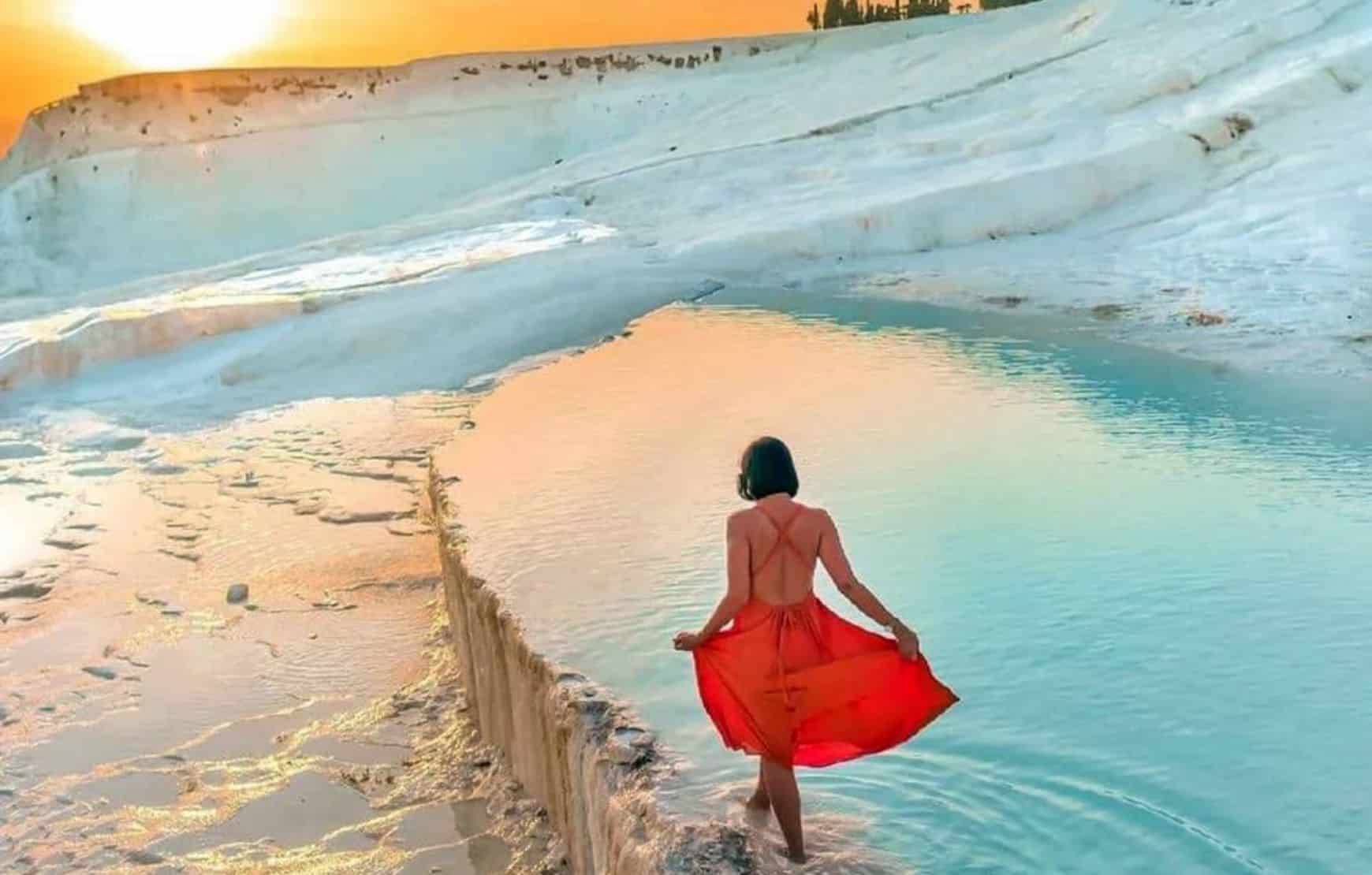 Woman in red dress in Pamukkale Travertines