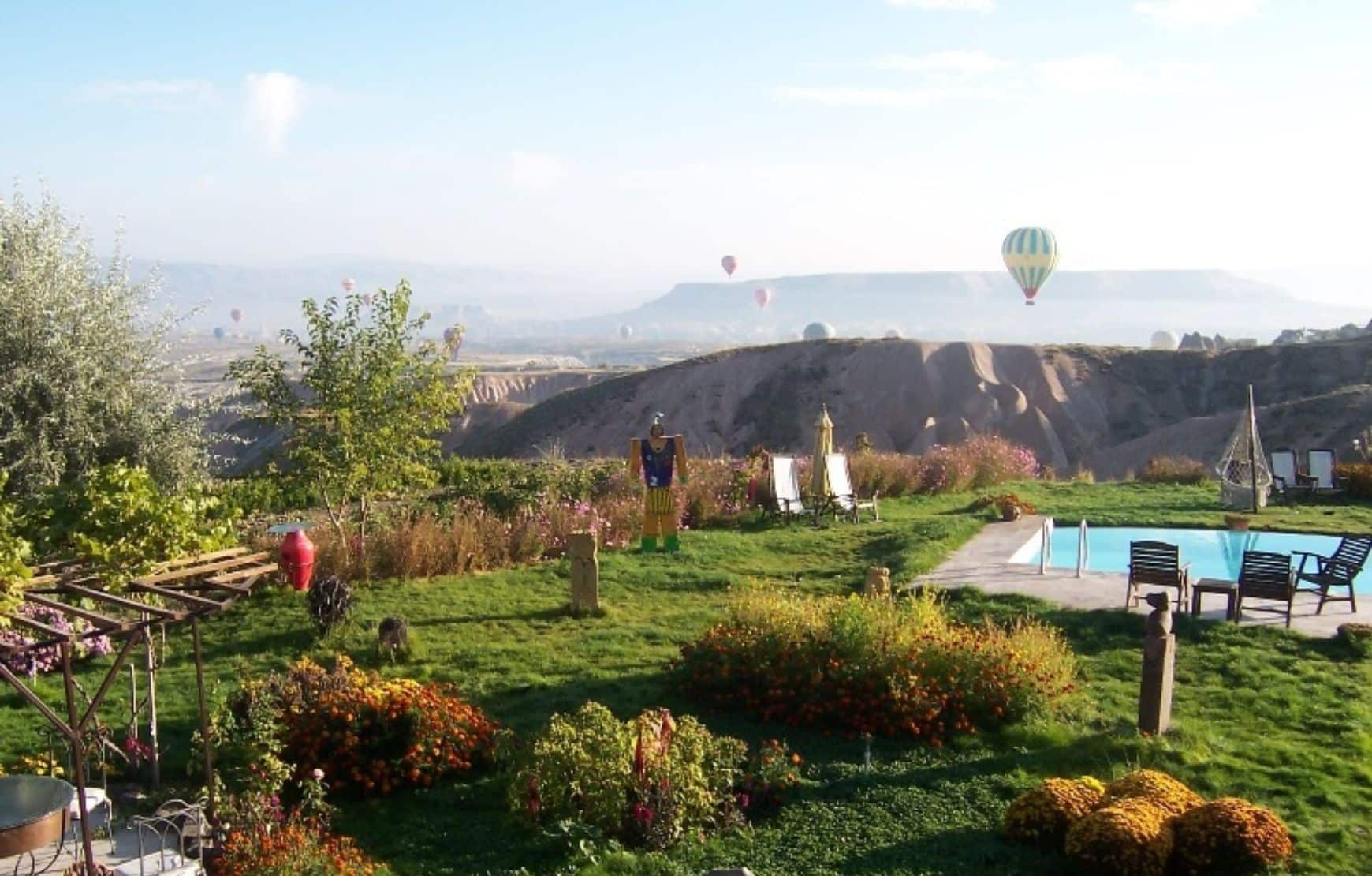 morning hot air balloons view at You glass-ceiling room at Karlik Evi Cappadocia