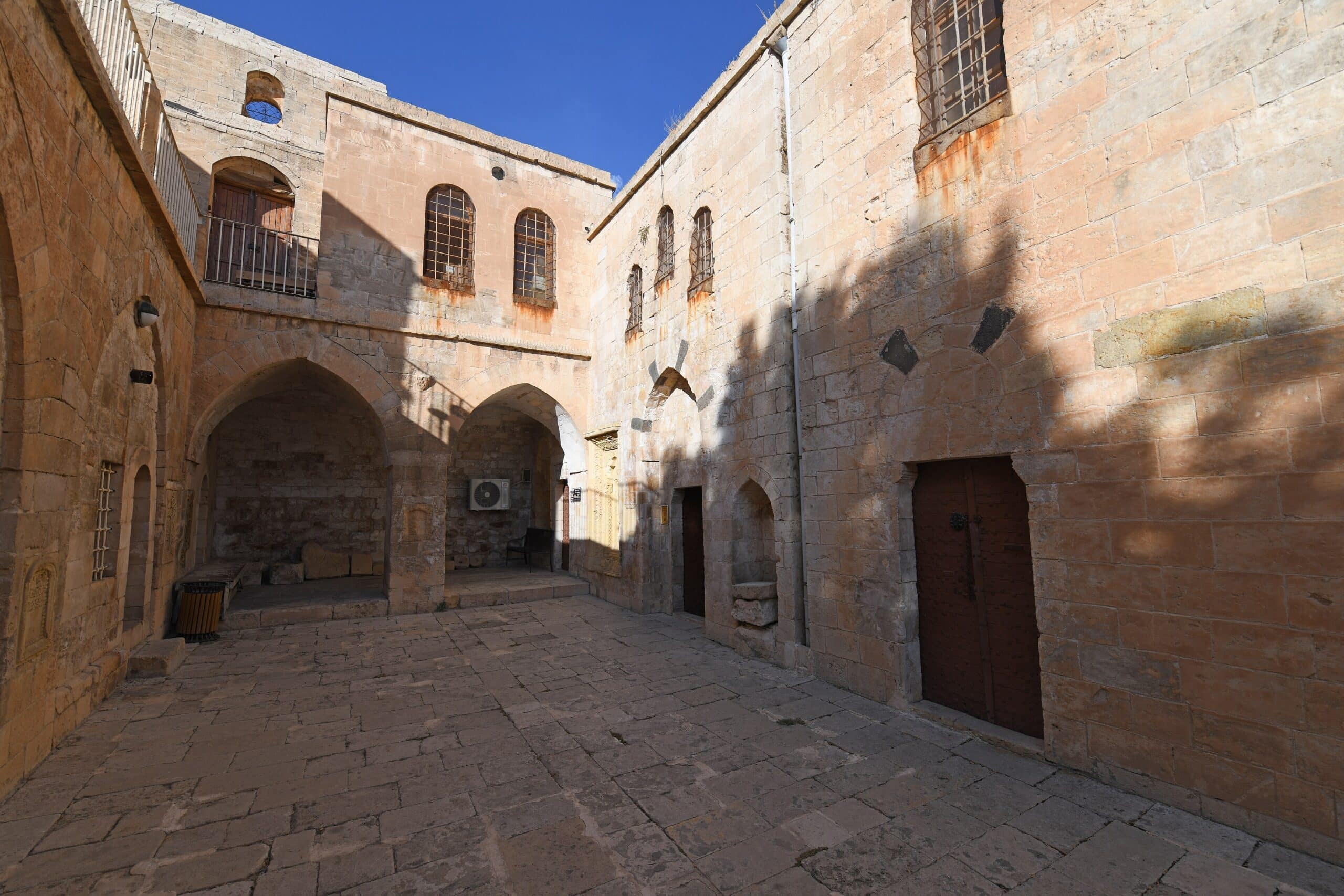 Kirklar Church - historic stone courtyard and arched architecture